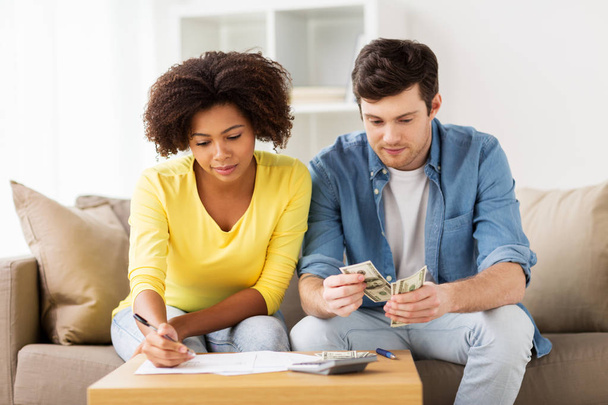 couple with papers and calculator at home - Foto, immagini