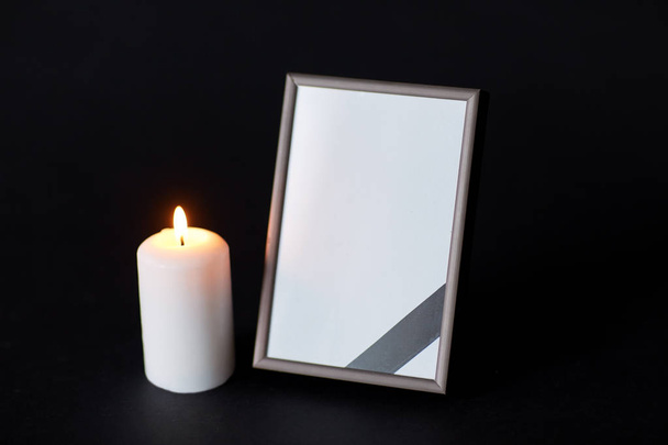 black ribbon on photo frame and candle at funeral - Photo, Image