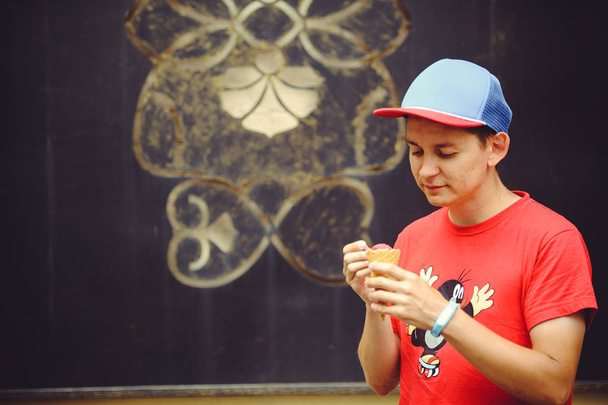 Young man with ice cream laughs - Photo, Image