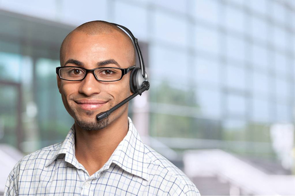 Portrait of a smiling man with headset  - Photo, Image