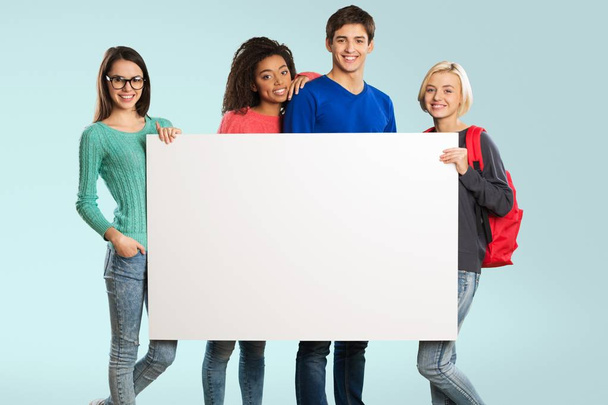 students with blank sign - Foto, Imagem
