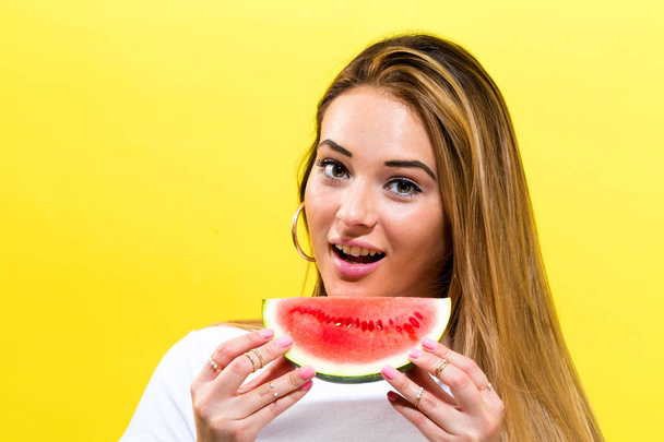 Happy young woman holding watermelon - Фото, изображение