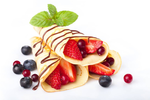 heap of rolled pancakes with berries - Fotoğraf, Görsel