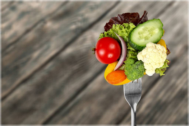 Fresh raw vegetables on fork - Photo, Image