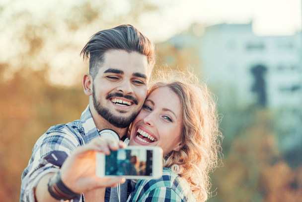 Smiling couple taking selfie  - Zdjęcie, obraz
