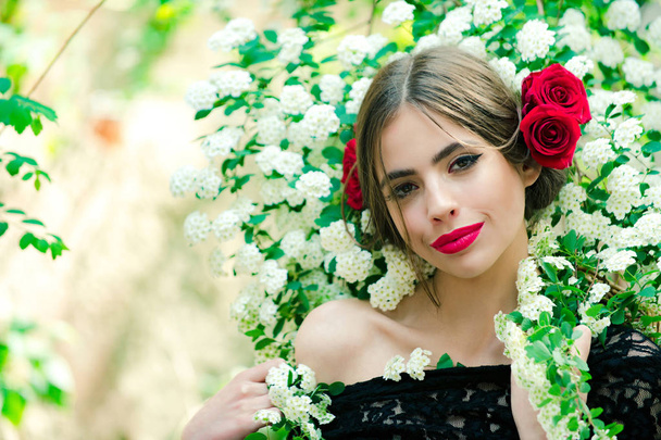 young beautiful woman with makeup and red flower in hairstyle - Foto, Imagem