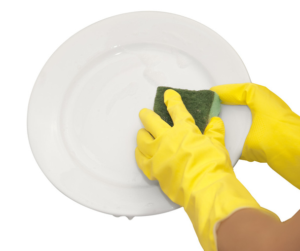 handen in gele handschoenen wassen witte plaat - Foto, afbeelding