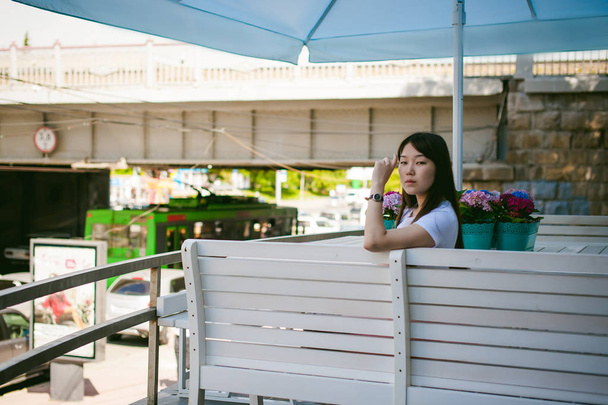 Cute asian young woman in summer cafe outdoors - Фото, зображення