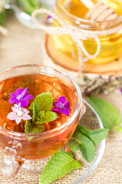 Glass cup of summer tea with herbs - Photo, Image