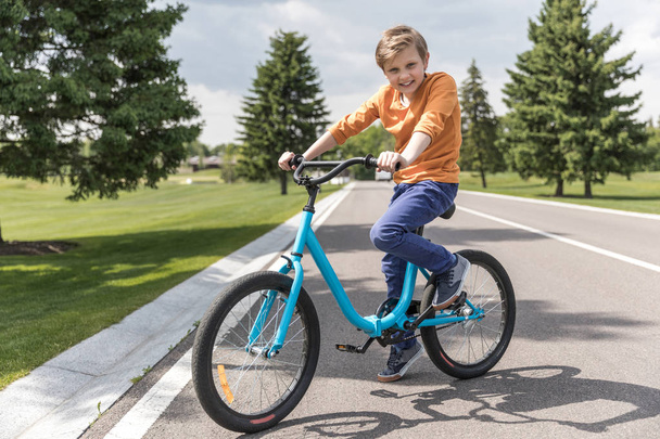 smiling kid boy riding bicycle - Fotoğraf, Görsel