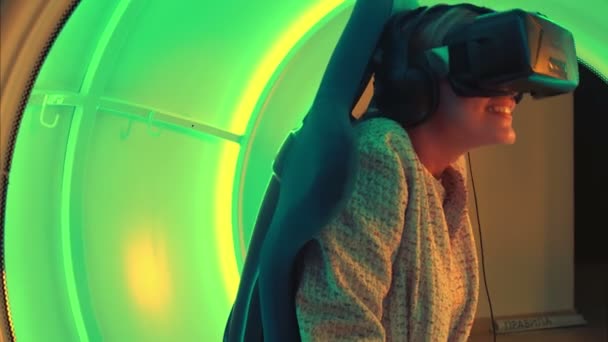Excited young woman enjoying virtual reality attraction - Footage, Video