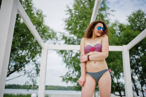 Portrait of an attractive girl posing in bikini with sunglasses  - Φωτογραφία, εικόνα