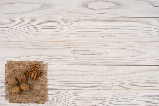 Walnuts on old white wooden table.  - Photo, Image