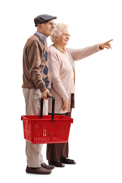 man with empty shopping basket and woman pointing - Fotó, kép