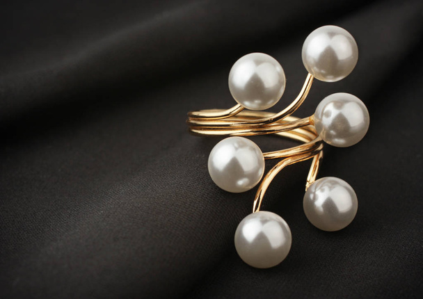 jewelry ring with pearl on black cloth, soft focus - 写真・画像