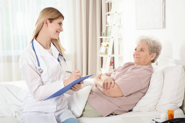 nurse and elderly woman  - Фото, зображення
