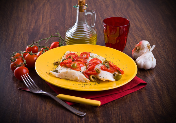 Fish fillet with cherry tomatoes and olive. - Photo, Image