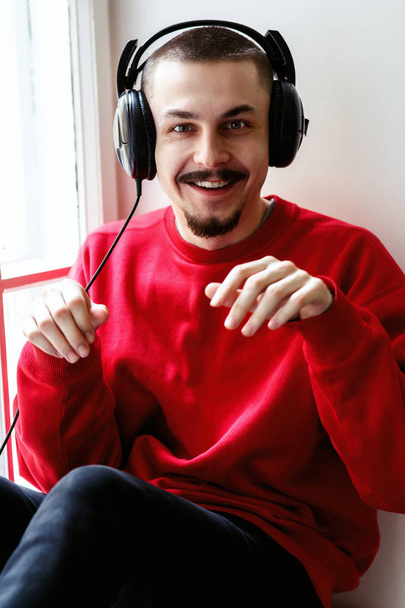 Man listening to music in headphones  - Фото, зображення