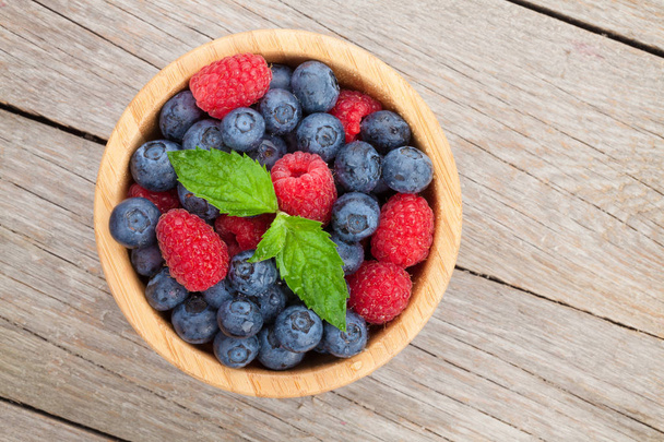 Blueberries and raspberries in bowl - Photo, Image