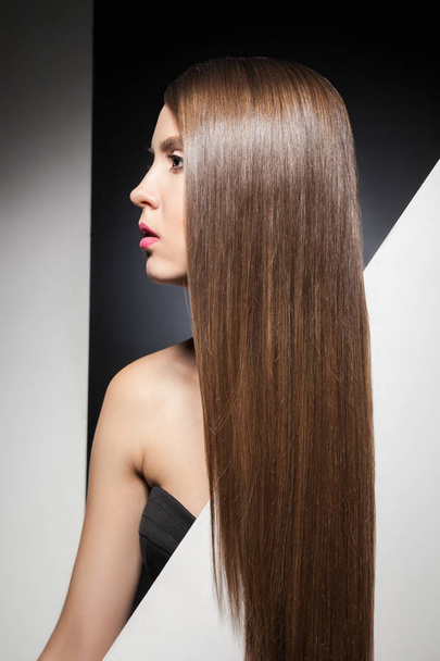 Portrait of long-haired brunette looking away - Fotografie, Obrázek