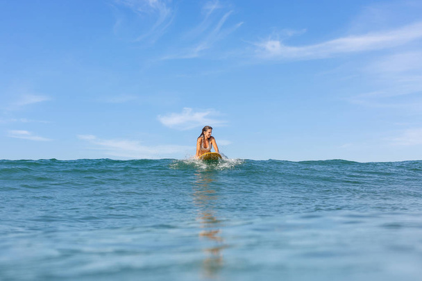 One beautiful sporty girl surfing in the ocean. - Foto, Imagen
