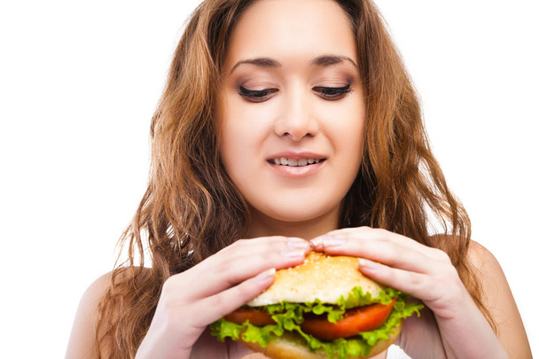 Happy Young Woman Eating big yummy Burger isolated - Photo, image
