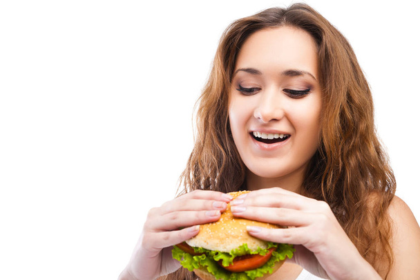 Happy Young Woman Eating big yummy Burger isolated - Photo, image