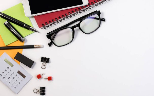 Business office desk table with office supplies and glasses with copy space. - 写真・画像
