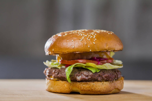 A large tasty burger on table - 写真・画像