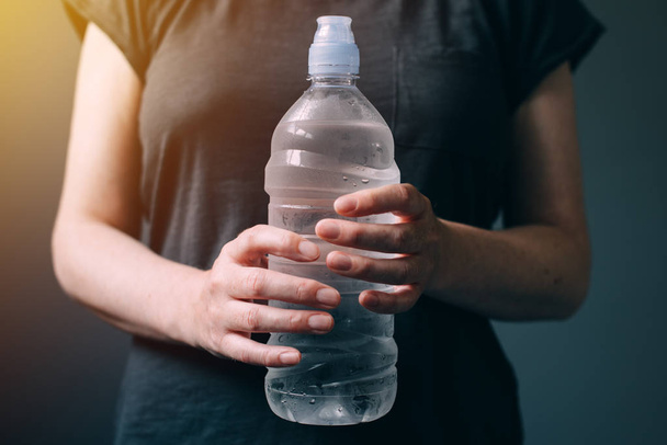 Woman with bottle of fresh drinking water - Фото, зображення