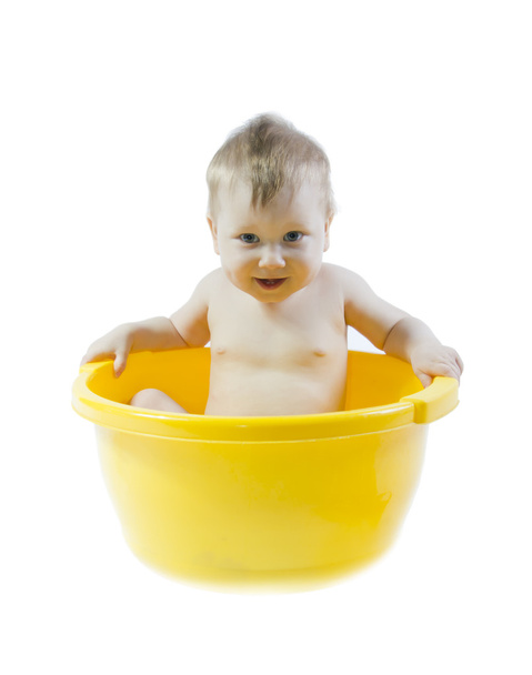 Cute baby taking bath in yellow tub - Valokuva, kuva