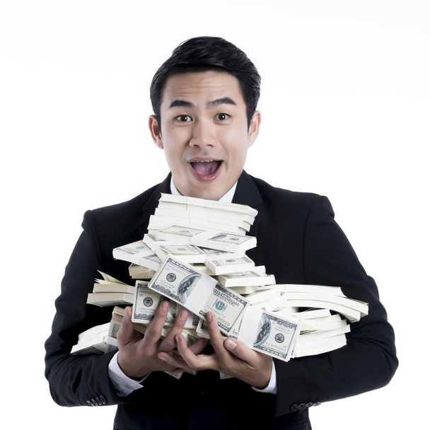 Close up the young businessman carrying a large pile of banknote - Foto, Imagem