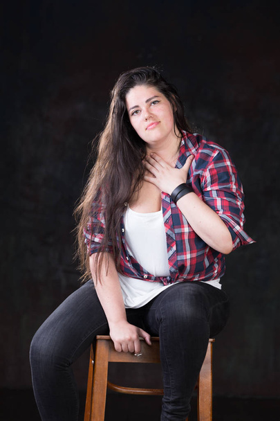 Beautiful plus size model with a dark long hair in a casual outfit - Fotografie, Obrázek