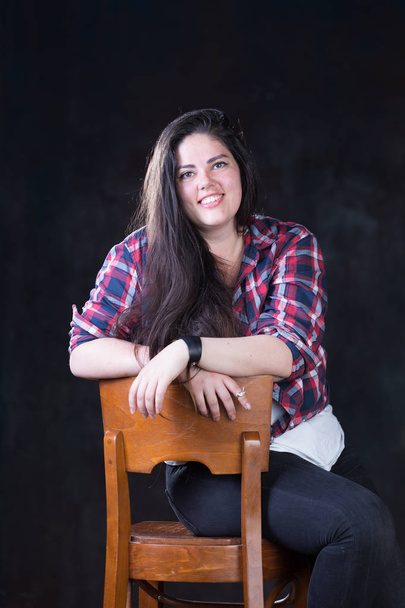 Beautiful plus size model with a dark long hair in a casual outfit - Foto, Imagen