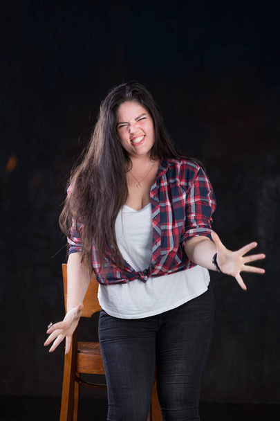 Beautiful plus size model with a dark long hair in a casual outfit - Foto, afbeelding