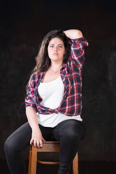 Beautiful plus size model with a dark long hair in a casual outfit - Φωτογραφία, εικόνα