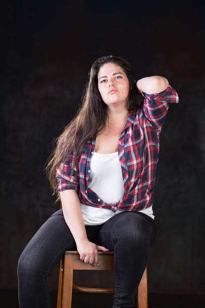 Beautiful plus size model with a dark long hair in a casual outfit - Φωτογραφία, εικόνα