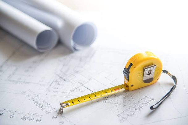 architectural drawing and tape measure on work table - Photo, Image