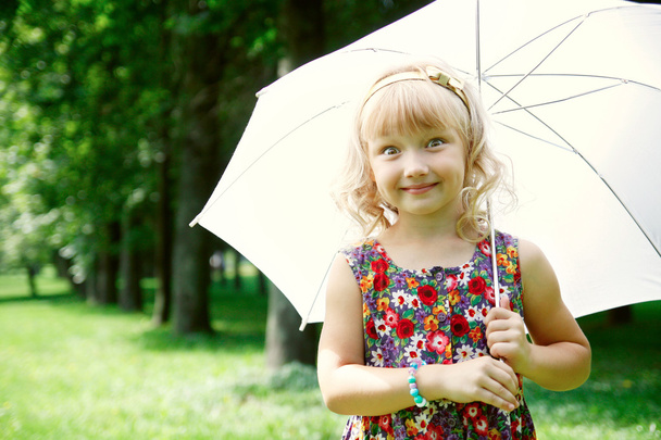 Little girl under umbrella - Фото, зображення