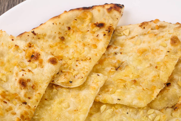 Naan with cheese and garlic - Фото, изображение