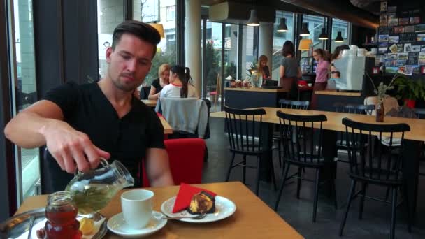 man refills his cup with tea and drinks - Footage, Video