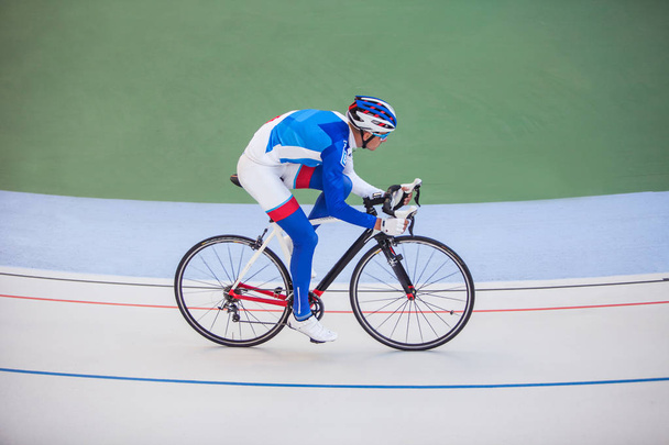 Racing cyclist on velodrome outdoor. - Photo, Image