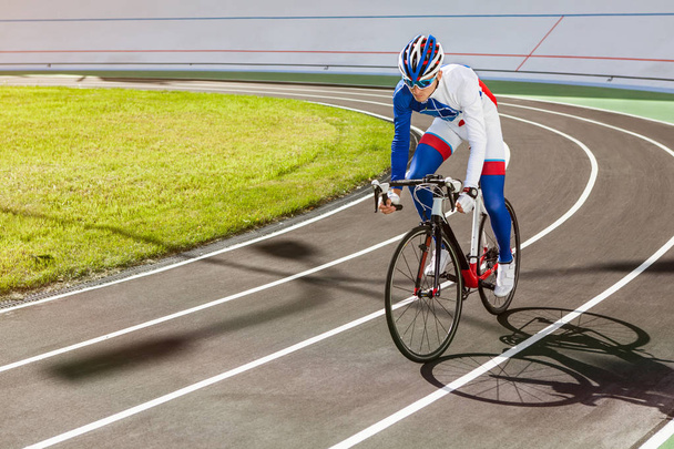 Racing cyclist on velodrome outdoor. - Photo, Image