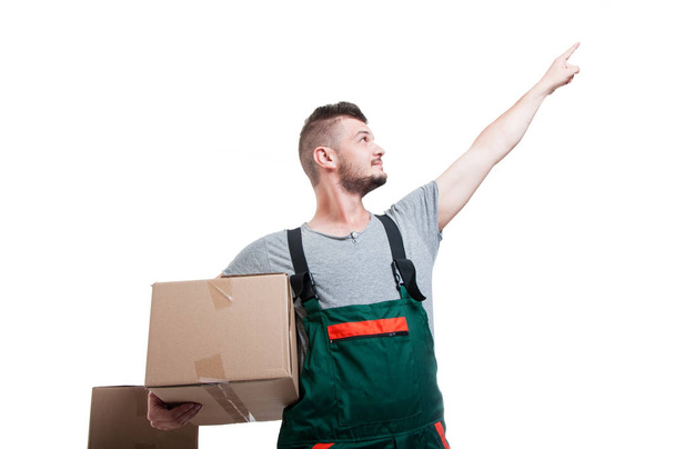 Low angle mover guy holding cardboard box pointing up - Photo, Image