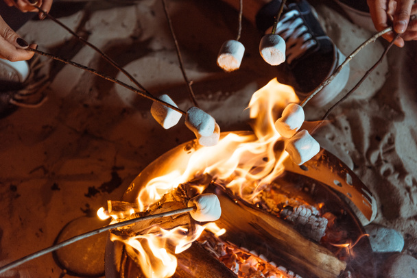 friends roasting marshmallows on bonfire - Photo, Image