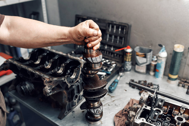 mechanic repairman at automobile car engine maintenance repair work. the crankshaft of the engine - Foto, afbeelding