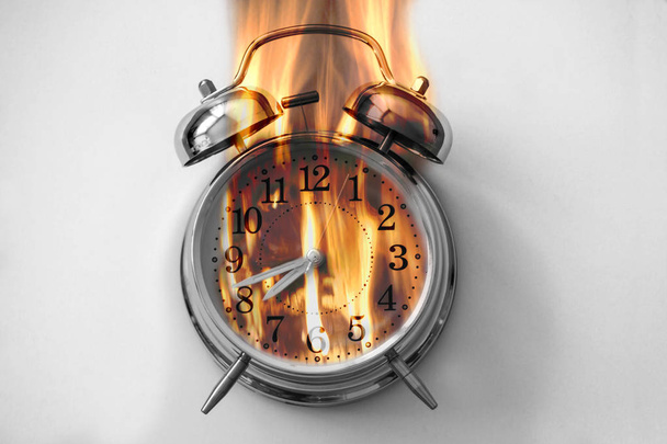Alarm clock is burning with fire flames - Foto, Bild