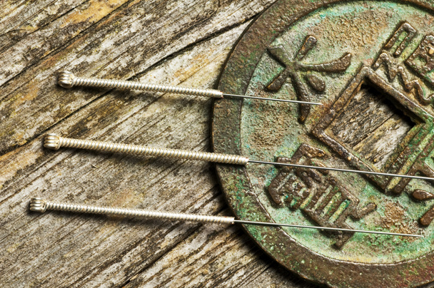 Acupuncture needles on chinese coin - Photo, Image