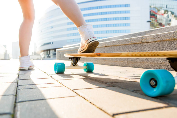 Girl with wooden longboard skateboard. - Foto, Bild