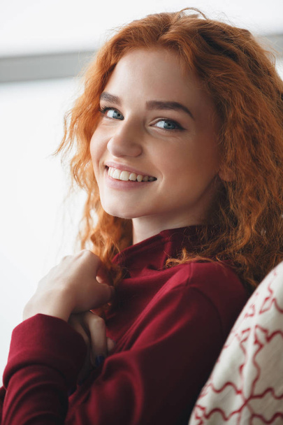 Close up portrait of a smiling young redheaded woman - Photo, image
